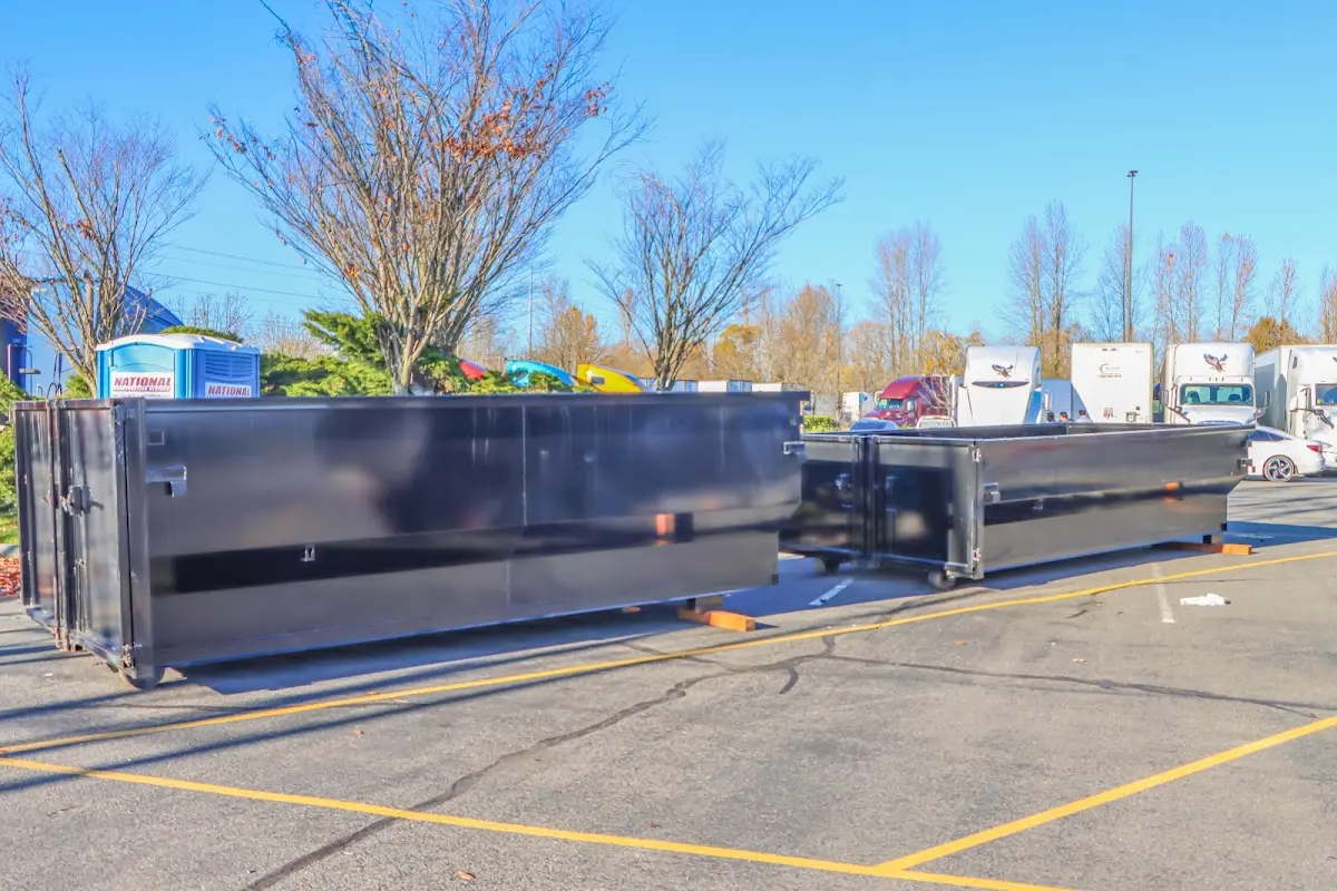 Professional dumpster rental service with roll-off container on residential driveway in Wickenburg